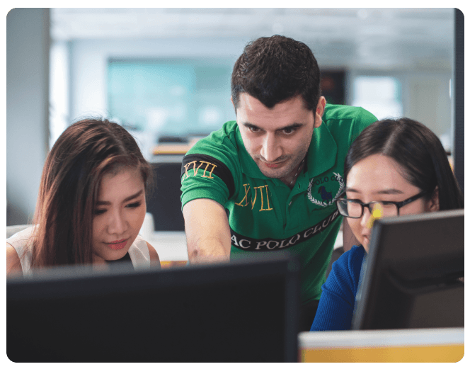 Young man teaching Verilog language to two young women